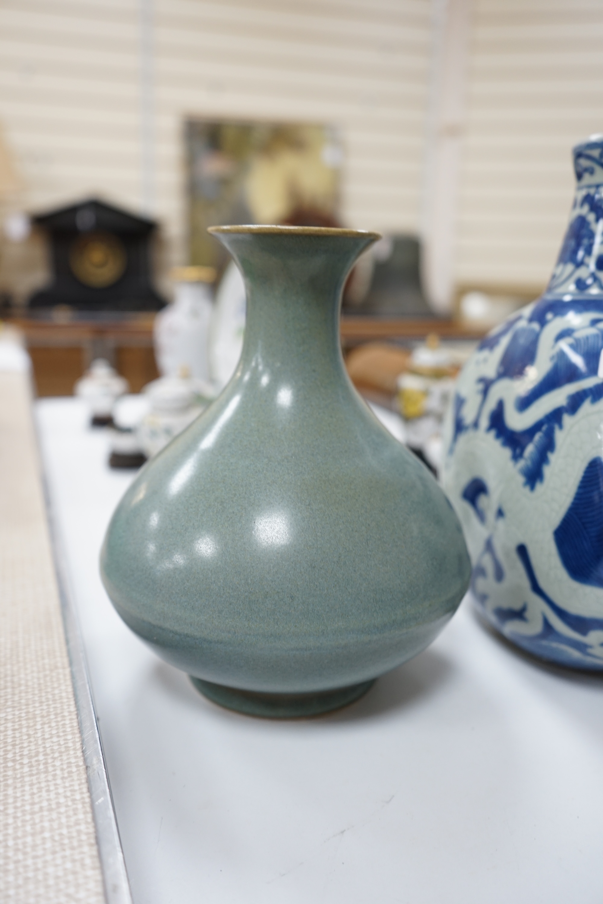 A large 19th century Chinese famille rose vase, a green glazed pear-shaped vase, and a blue and white dragon flask (3). Condition - poor to fair.